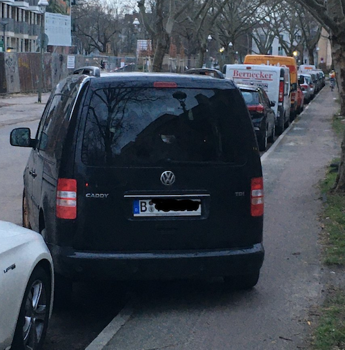 "Car blocking bike path"